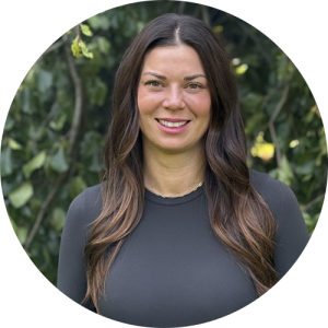 A woman outside, smiling.