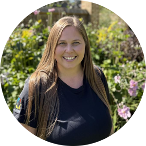 A woman outside, smiling.