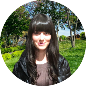 A woman outside, smiling.